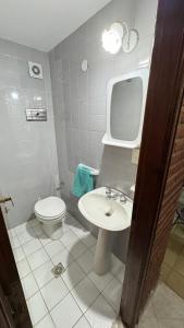 a bathroom with a white sink and a toilet at Casa Calamar I in Valeria del Mar