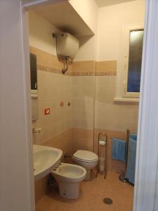 a bathroom with a toilet and a sink at EUR Laurentina vacation home in Rome
