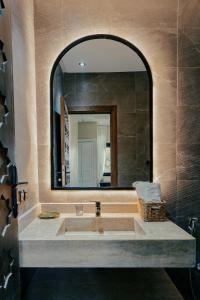 a bathroom with a sink and a large mirror at Stunning luxury Villa with Mountain Views in Sbiti