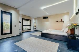 a bedroom with a bed and two rugs at Stunning luxury Villa with Mountain Views in Sbiti
