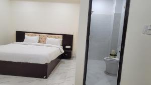 a bedroom with a bed and a shower and a toilet at Samriddhi Homestay in Varanasi