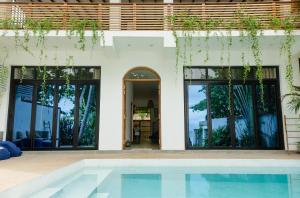 a house with a swimming pool in front of it at Parasol Doré - Boutique Hotel - in Dickwella