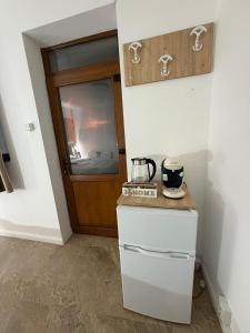 a small kitchen with a counter and a door at Casa Cota in Craiova +1 photo