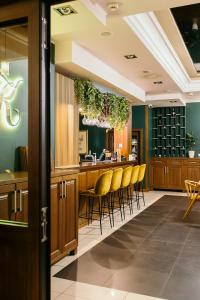 un bar in un ristorante con sgabelli gialli da bar di Hotel Kresowiak a Siemiatycze