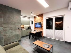 a living room with a couch and a table at Pod Palmami in Hel