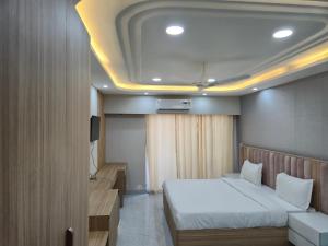 a hotel room with a bed and a tv at Hotel Grand Luxury Char Dham in Vrindāvan