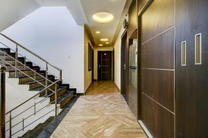 a hallway with a staircase and a stair case at Hotel O Bonsai in Bhopal