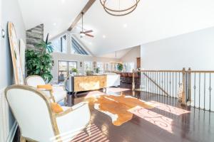 a living room with a couch and a piano at Tranquility Paradise in Sevierville