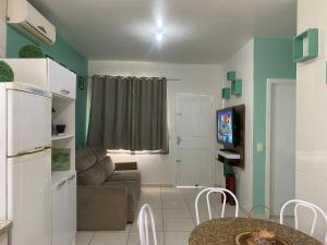 a living room with a couch and a table at Residencial Arcoiris in Palhoça