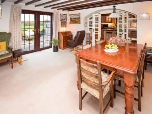 a dining room with a wooden table and chairs at 1 Stag Inn Cottages in Milburn