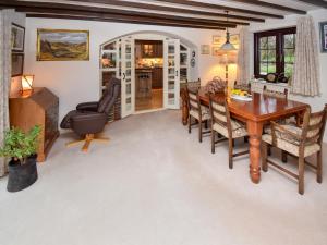 a dining room with a wooden table and chairs at 1 Stag Inn Cottages in Milburn