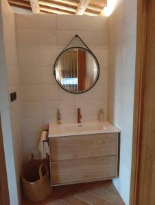 ein Badezimmer mit Waschbecken und Spiegel in der Unterkunft Natura-Resort Les Pletes in Palouet