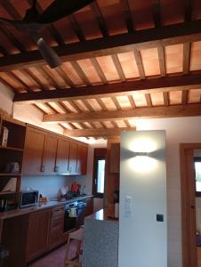 eine Küche mit Holzdecken und einem weißen Kühlschrank in der Unterkunft Natura-Resort Les Pletes in Palouet