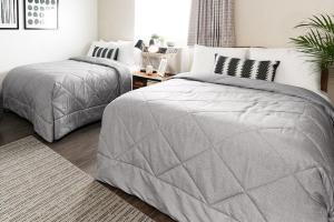 a bedroom with two twin beds and a table at InTown Suites Extended Stay Savannah GA in Savannah