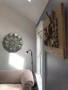 a room with a lamp and a wall with a window at The Downtown Loft in Buncrana +2 photos