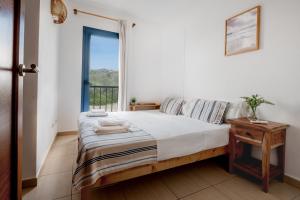 a bedroom with a bed and a window at Ca na Magdalena in Cala d´Or +25 photos