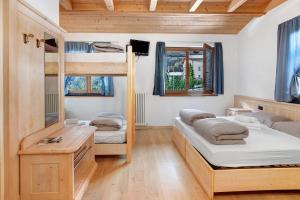 a room with two bunk beds and a desk at Agriturismo Quinto Quarto in Sondalo