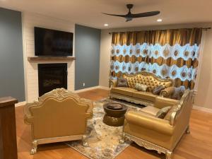 a living room with two couches and a fireplace at Luxurious Sweet Escape stunning custom Home! in Rochester