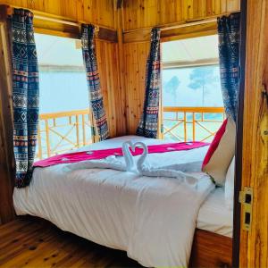 a bedroom with a bed with two swans on it at Lee's Charm Homestay in Sa Pa