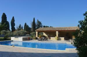 a villa with a swimming pool and a patio at La Bastide Des Oliviers in Châteaurenard