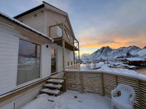 a balcony of a house with snow on it at Aurora Bay Villa Lofoten 罗弗敦极光湾海景顶层别墅 in Sund