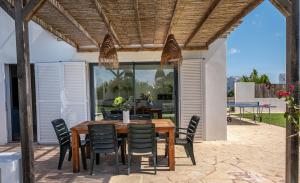 a wooden table and chairs on a patio at Ca na Magdalena in Cala d´Or