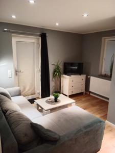 a living room with a couch and a coffee table at Stadtnah an der Förde 5705 in Flensburg