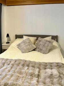 een bed met twee kussens erop bij Traditional Lapland Studio Peaceful and Simple in Rovaniemi