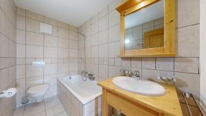 a bathroom with a sink and a toilet and a mirror at Plein Ciel VA 032 - MOUNTAIN apartment 6 pers in Veysonnaz +25 photos