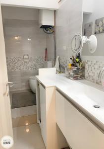 a white bathroom with a sink and a toilet at Paty's House Milano in Milan
