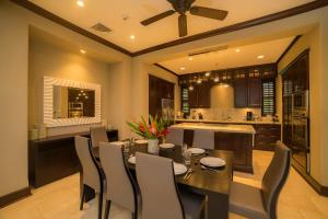 a kitchen and dining room with a table and chairs at Vista Bahia 3D 3 bdr Ocean View in Los Suenos in Herradura