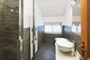 a bathroom with a toilet and a shower at Appartamento Primavera 3 in Moena +22 photos