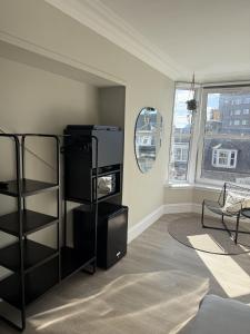 a living room with a black book shelf at Park House Rooms in Aberdeen +2 photos