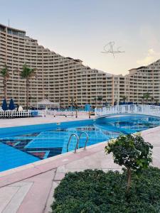 a large hotel with a large swimming pool with a large building at Apartments in Ain Sokhna in Porto in Ain Sokhna