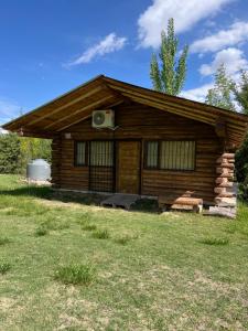 a log cabin with a television on the side of it at Altandes Cabañas in Vista Flores