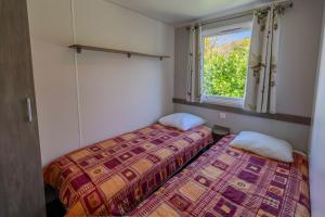 Ένα ή περισσότερα κρεβάτια σε δωμάτιο στο Mobil-home climatisé 4 pers