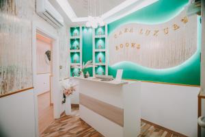 a office with a desk and a wall with writing on it at Cama Luxury Rooms in Palermo