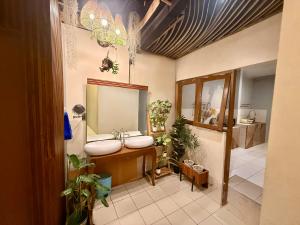 a bathroom with two sinks and a mirror at Buton Backpacker Lodge in Bandung +34 photos