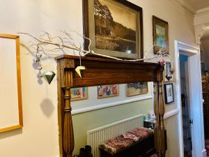 a living room with a table and a mirror at Fitz House in Keswick