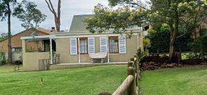a house with a fence in front of a yard at Town and Country in Caledon