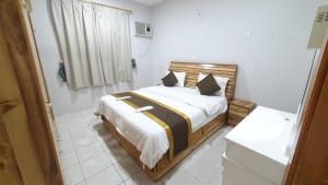 En eller flere senge i et værelse på شقق نماء الفندقية