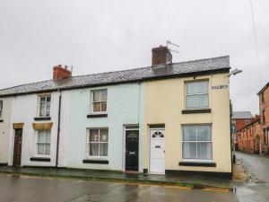 an old house on the side of a street at 6 Church Lane in Llanidloes
