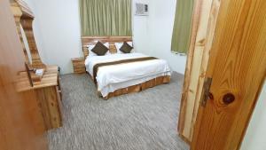 En eller flere senge i et værelse på شقق نماء الفندقية