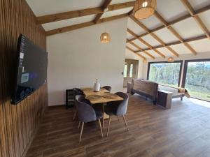 Μια τηλεόραση ή/και κέντρο ψυχαγωγίας στο HOM I Cabaña La Ensenada vista parcial al Volcán