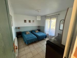 a bedroom with a bed and a television in it at La borie de la croix in Daglan