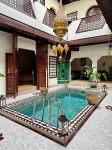 a pool in the middle of a building at Riad Jolie in Marrakesh