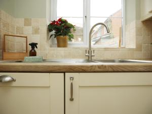 a kitchen counter with a sink and a window at Orchard Place Semington By N And N Stays, 20 Mins From Bath, Perfect for Contractors and Workers, Pvt Parking for 2 vehicles  +64 photos