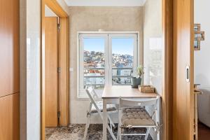 a small room with a table and a window at GuestReady - Terrace Cozy Stay in Coimbra