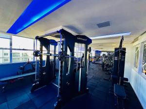 a gym with rows of treadmills and machines at Madrid 1101 in Sao Jose do Rio Preto