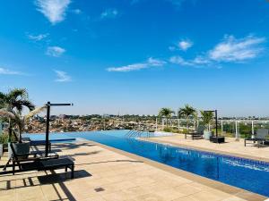 a swimming pool with a view of the city at Madrid 1101 in Sao Jose do Rio Preto